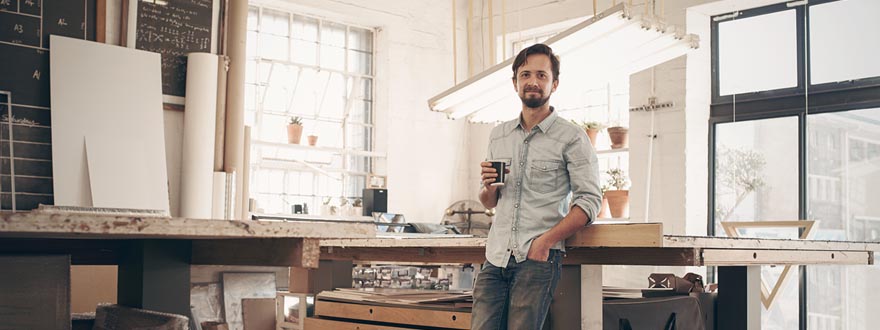 Architect in a studio holding a cup of coffee
