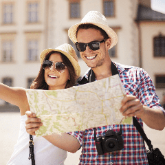 Image of two tourists exploring a scenic location and looking at a map.