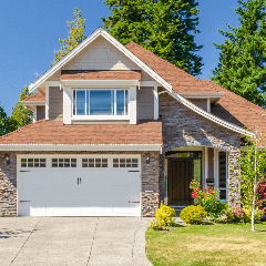 Image of a house with a driveway leading up to it.